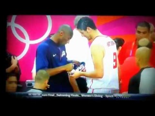 Kobe Bryant Signs the Shoe of a Player on Team Tunisia After the Game