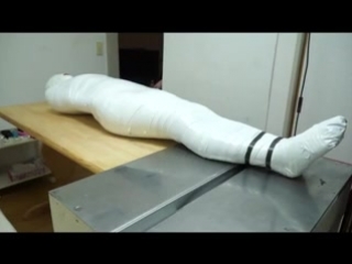 Japanese Girl mummified and breathplay in white tape.