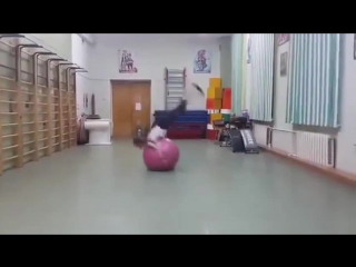 Girl does backflips with exercise ball