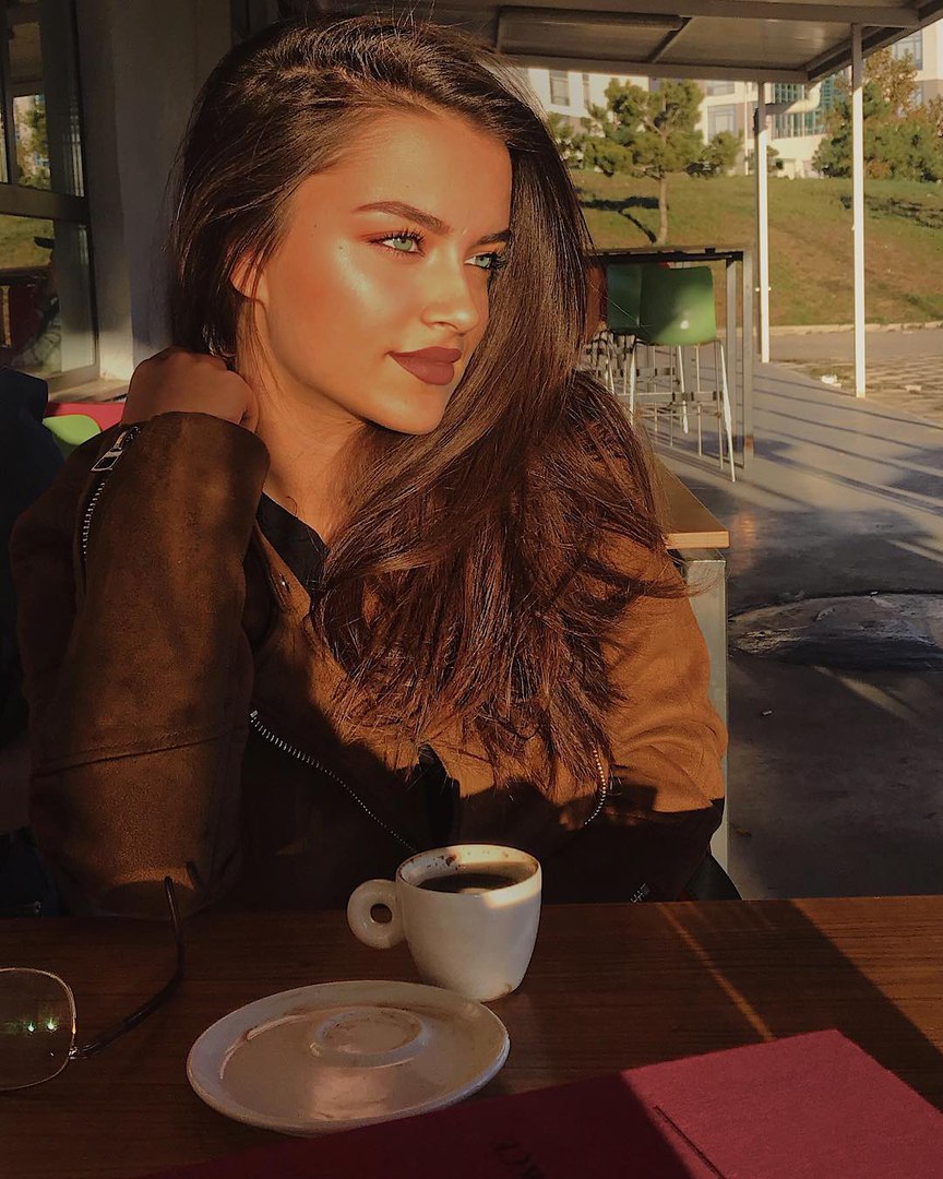 Cute teen drinks a glass of wine
