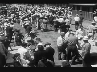 Japanese-American victims arriving at one Exterminating Camp. Notice the machinegun tower at electric fence in background.