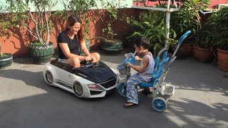 Dylan on a Kiddie Trike Against Mommy Riding a Toy Car