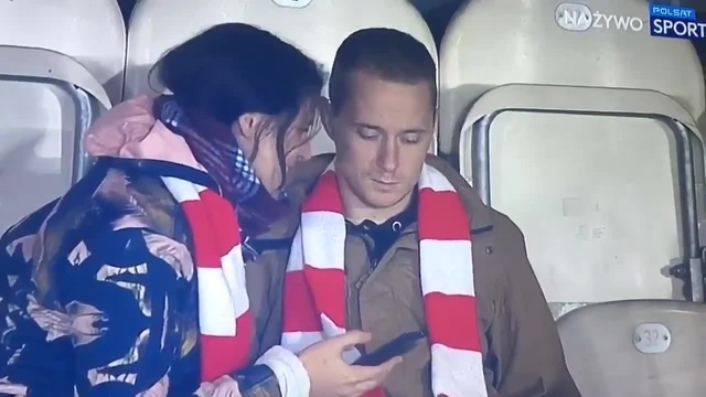 With a woman at the match